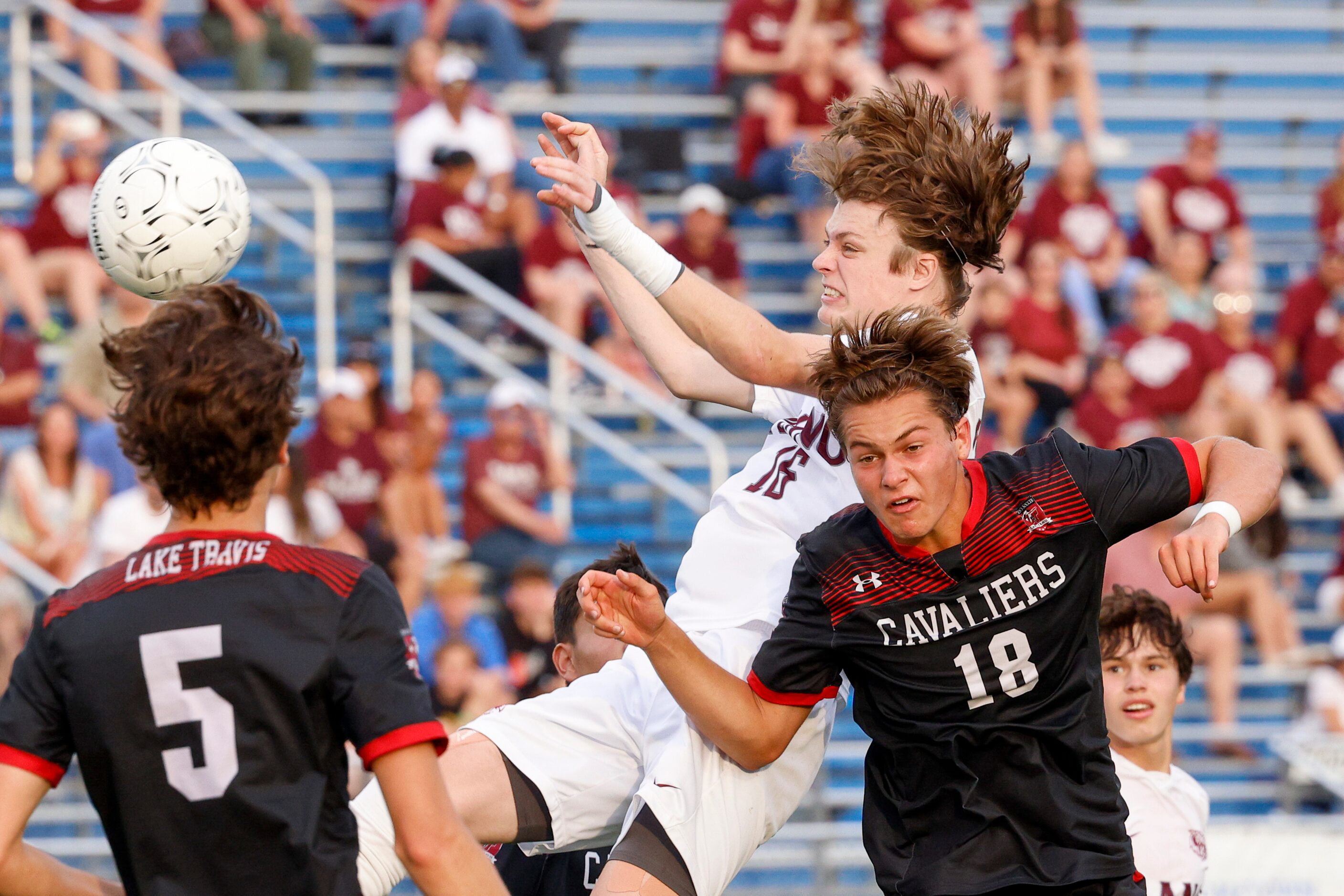 Plano forward Nolan Giles (16) heads the ball towards goal over Austin Lake Travis defender...