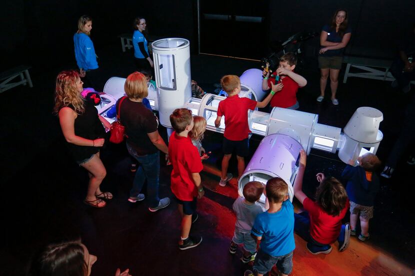 Children and adults get to play with a hands-on model resembling the International Space...