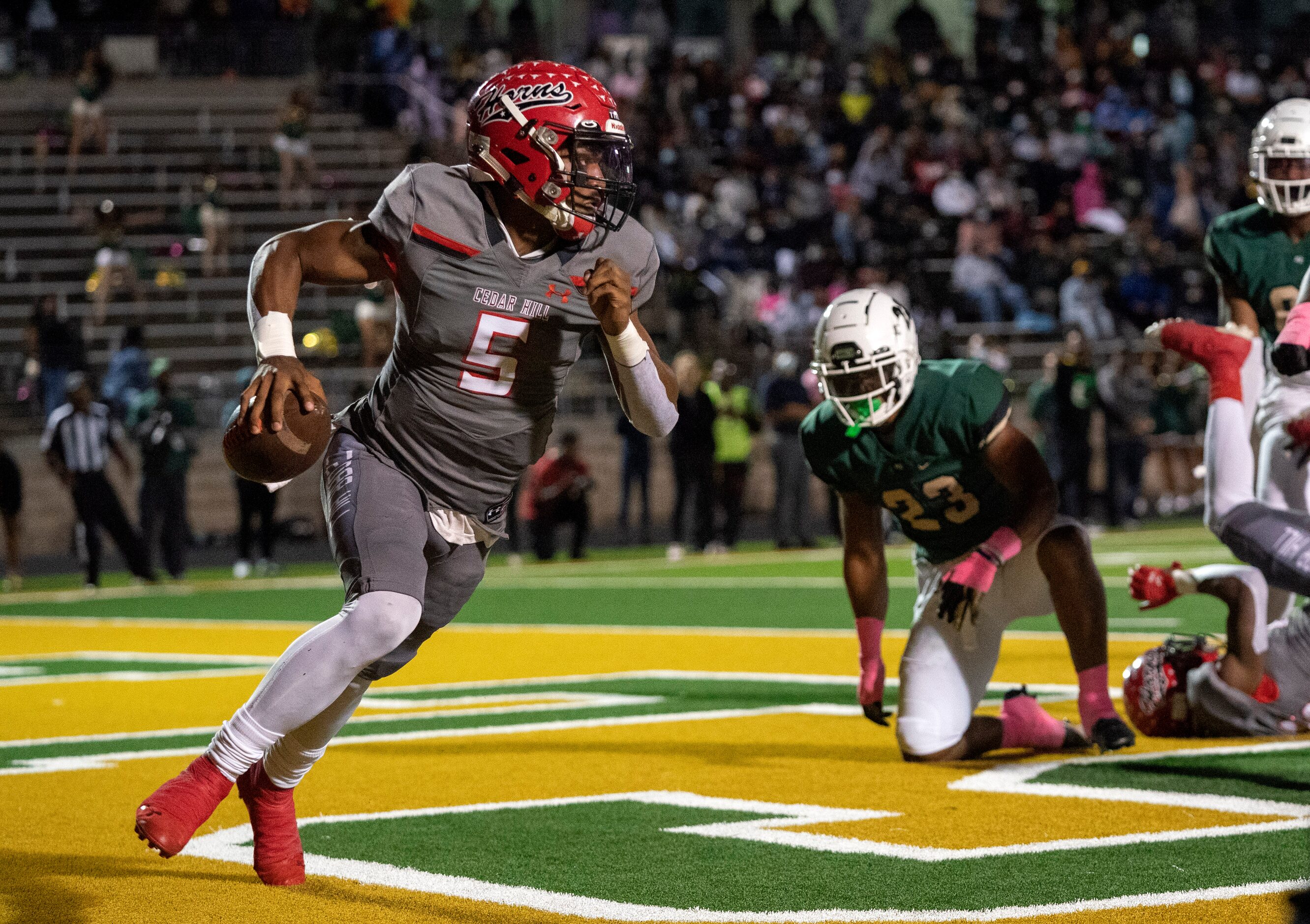 Cedar Hill junior quarterback Cedric Harden, Jr. (5) scrambles in his own end zone during...