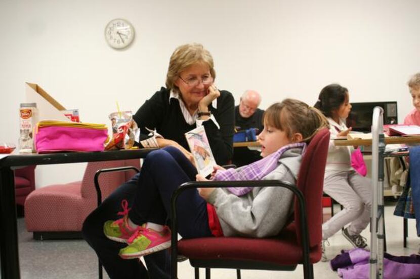 
Volunteer Cheryl Alexander listens to Lauren Smith, 6, read aloud.
