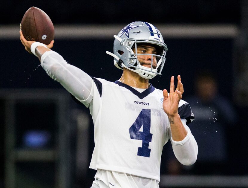 Dallas Cowboys quarterback Dak Prescott (4) throws a pass during a Dallas Cowboys OTA...