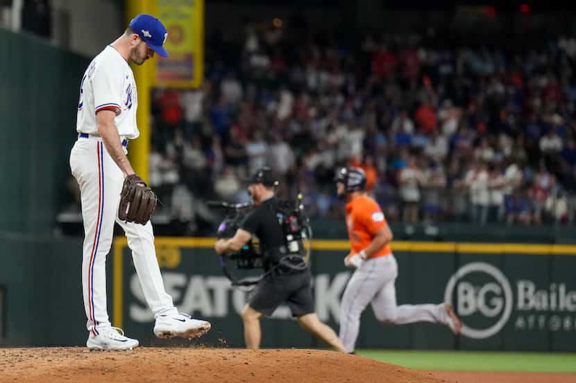Texas Rangers pitcher Cody Bradford (61) reacts after giving up a home run to Houston Astros...