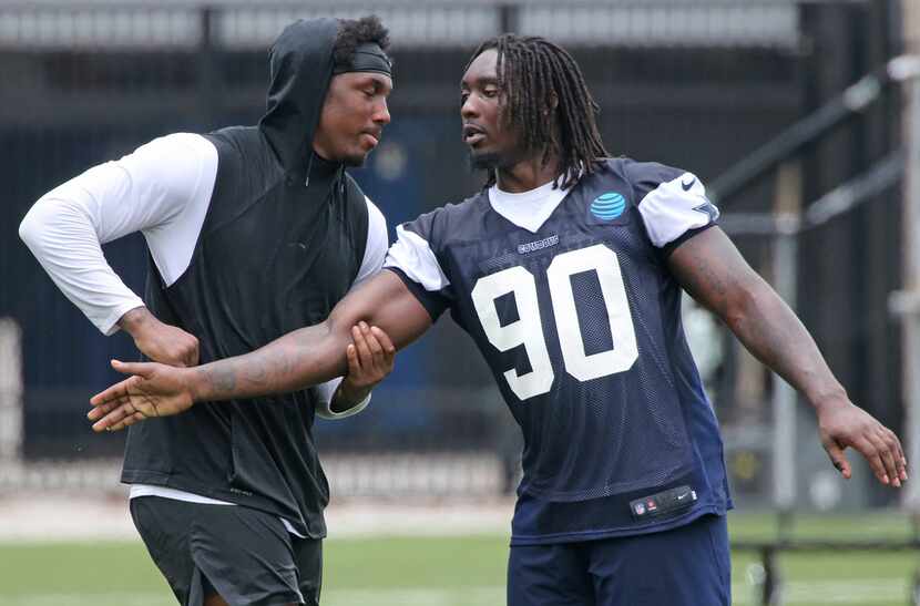 Dallas Cowboys defensive ends Demarcus Lawrence (90), right, and Taco Charlton (97) work on...
