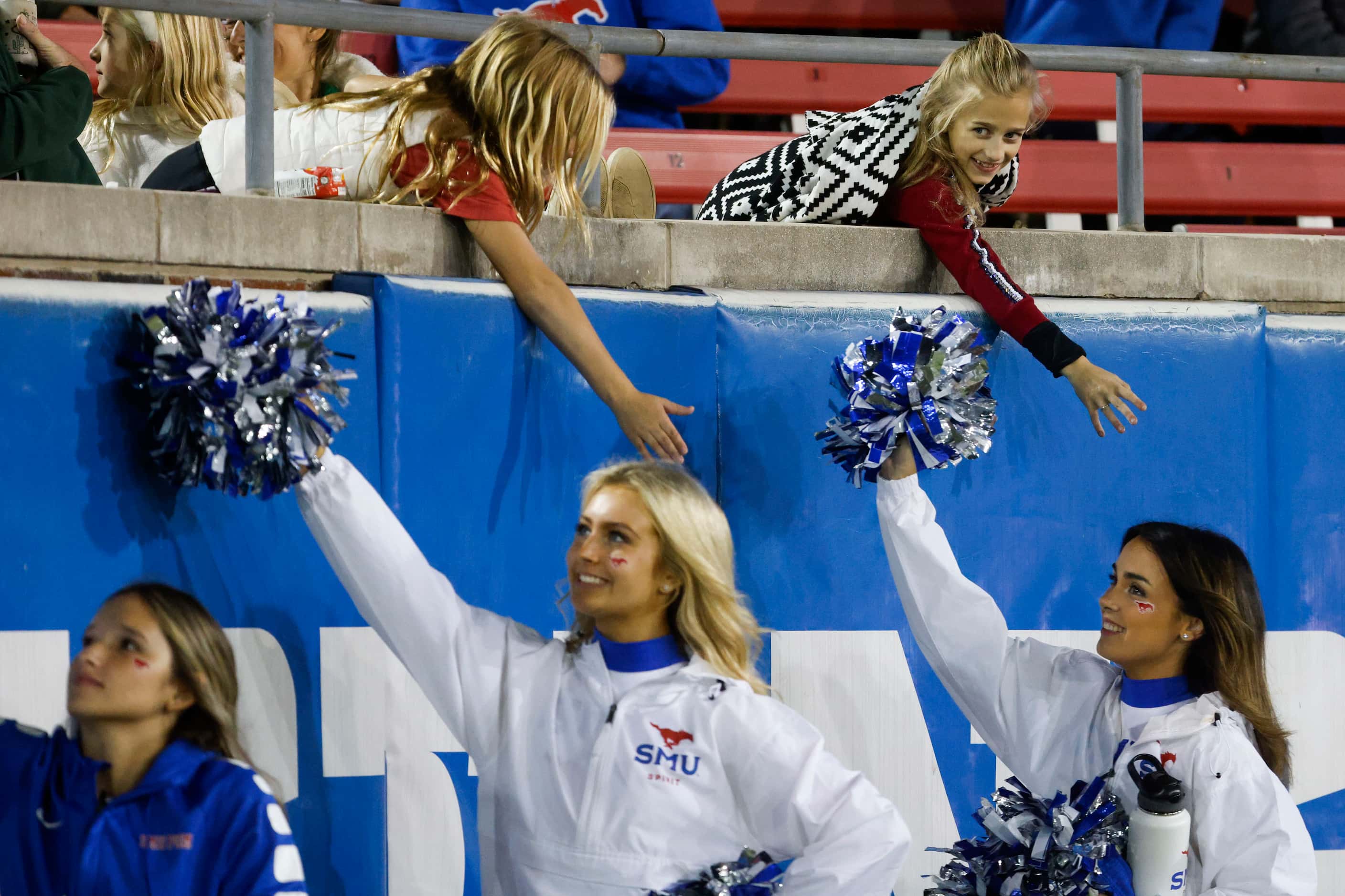 SMU cheerleaders high-fives young fans during the second half of a football game against UNT...