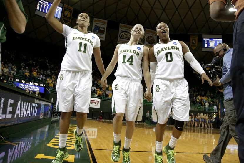 Baylor seniors Mariah Chandler, from left, Makenzie Robertson, and Odyssey Sims, right, hold...