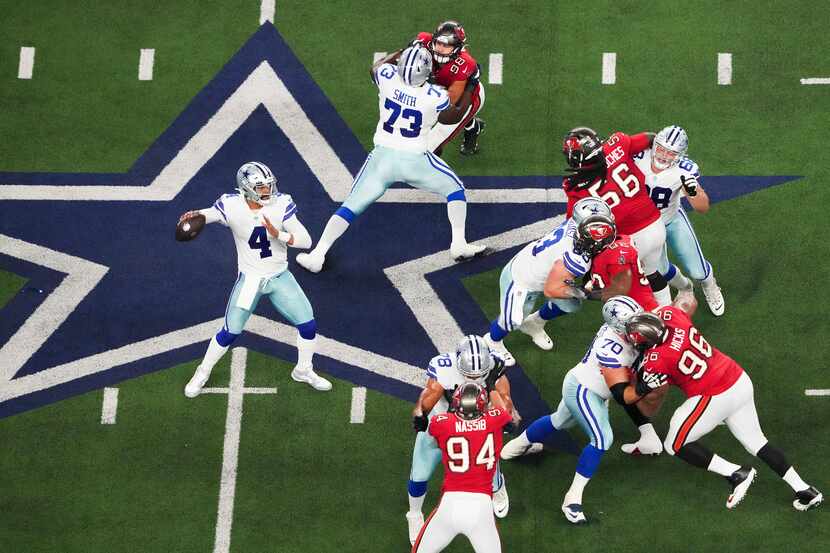 Dallas Cowboys quarterback Dak Prescott (4) throws a pass behind an offensive line of Tyler...