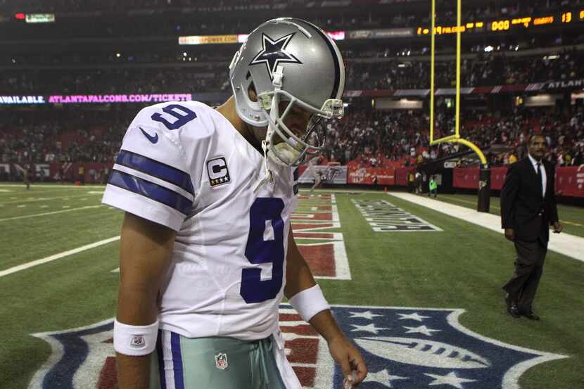 Dallas Cowboys quarterback Tony Romo (9) walks off the field following a 19-13 loss against...