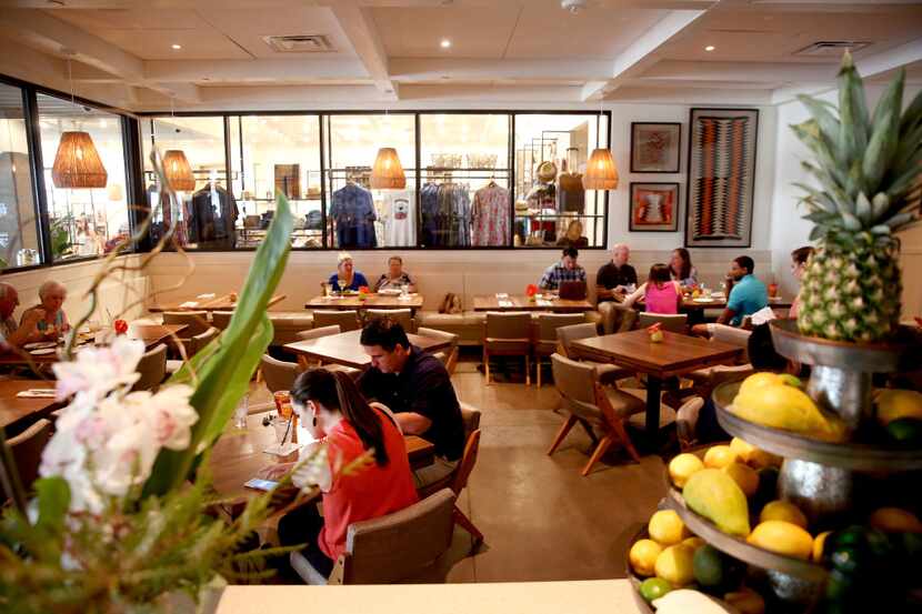 Patrons dine at the Tommy Bahama restaurant and store location at Legacy West in Plano on...