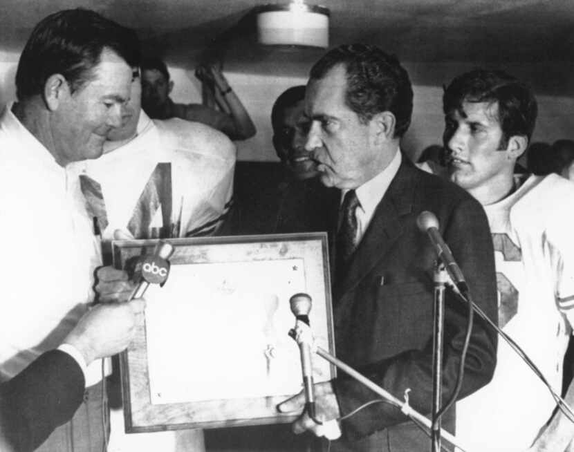 University of Texas football Darrell Royal excepts a plaque from president Richard Nixon...