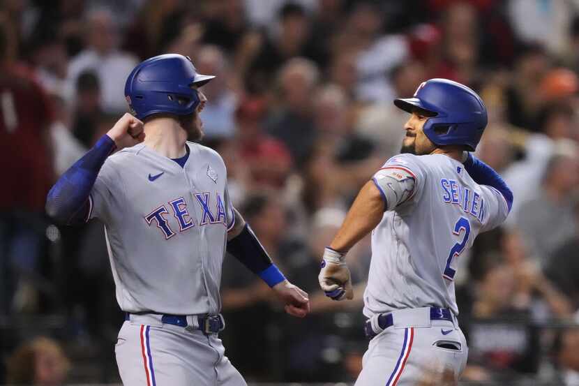 Texas Rangers’ Marcus Semien (2) celebrates hitting a three-run home run with Jonah Heim,...