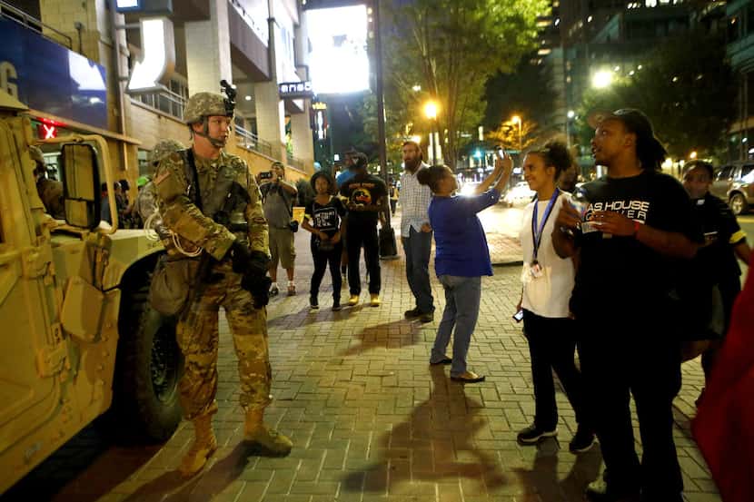 Members of the North Carolina Nation Guard speak with residents and visitors in Uptown...