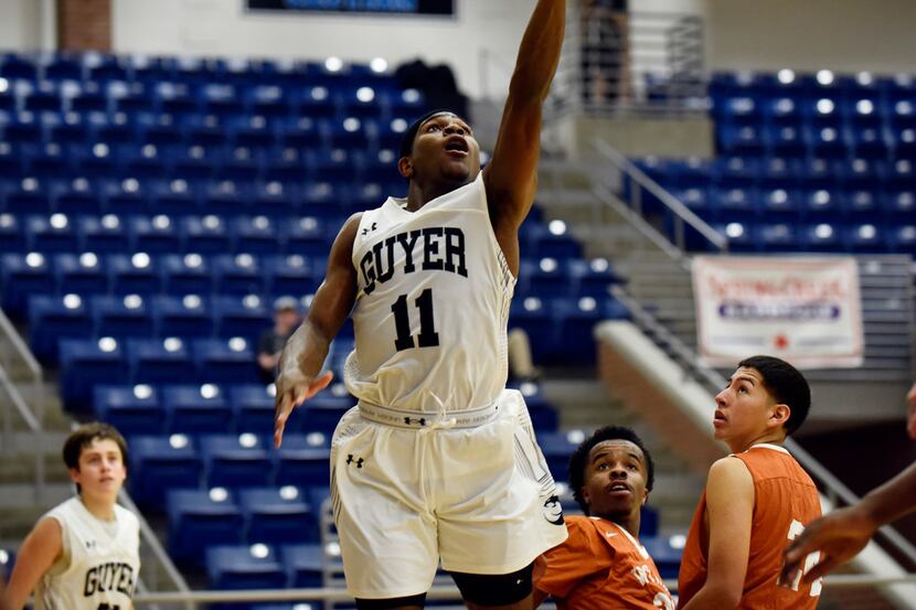 Denton Guyer junior De'Vion Harmon (11) leaps for a layup during a first round game of the...