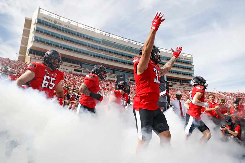 Texas Tech's Matthew Young (33) raises his arms while running onto the field before an NCAA...