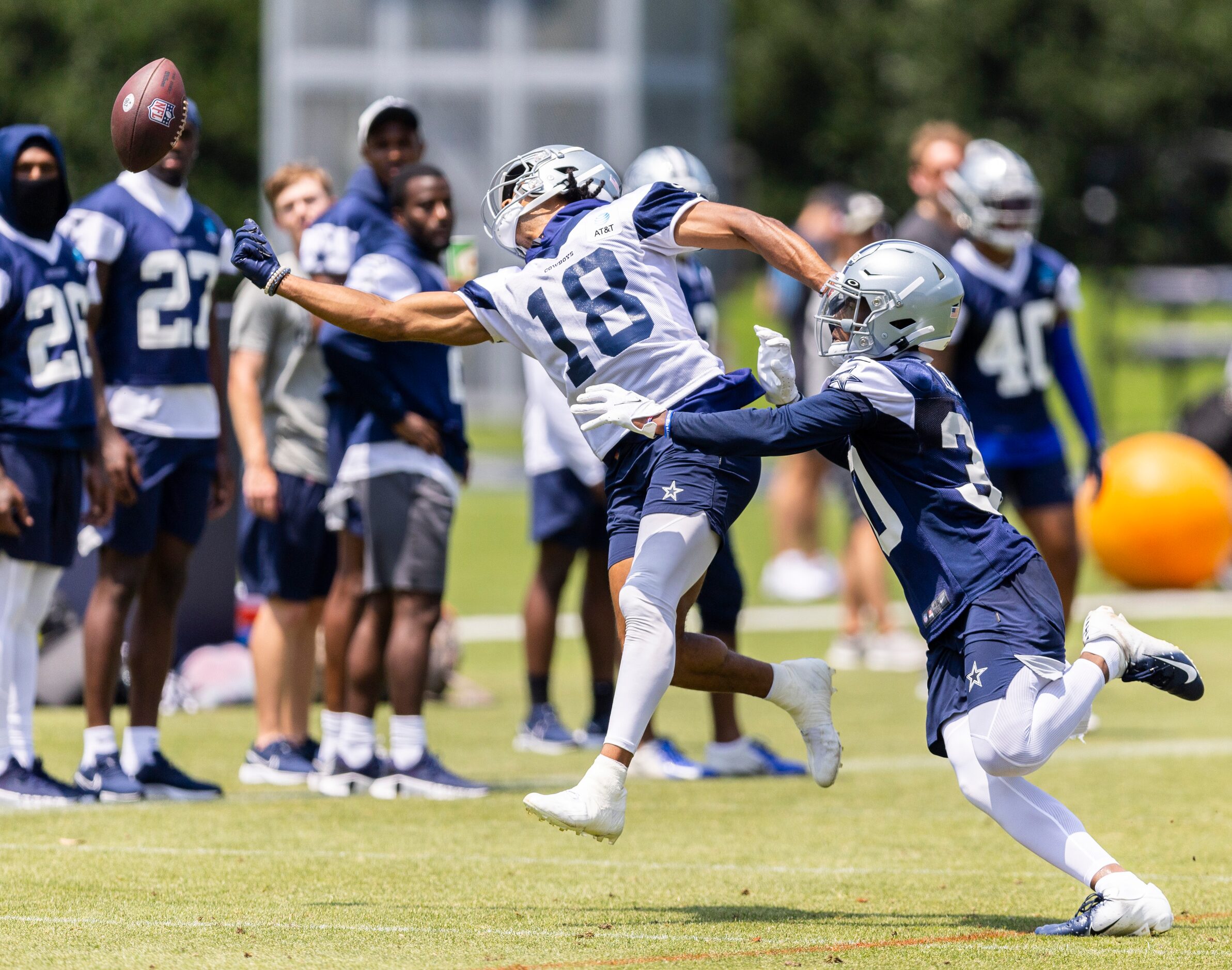 Dallas Cowboys wide receiver Jalen Tolbert (18) reaches for a pass as cornerback DaRon Bland...