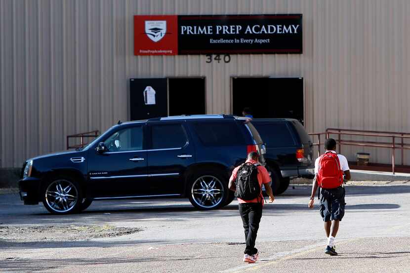 Two young men walked toward a school building on the first day of classes at Prime Prep...