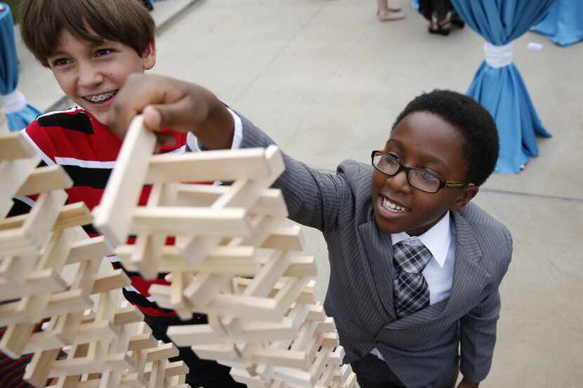  Peter Van Ausdale, 12, left, and Najm Muhammad, 11, built block towers at the unveiling of...