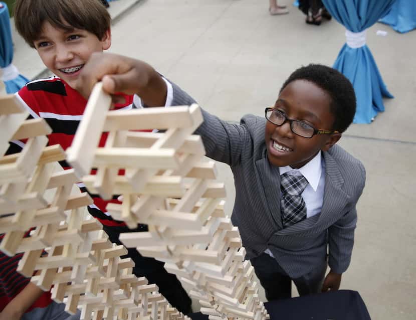  Peter Van Ausdale, 12, left, and Najm Muhammad, 11, built block towers at the unveiling of...