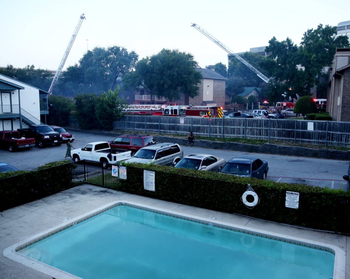 Dallas Fire-Rescue personnel worked to put out Monday's fire at the Landmark at Rosewood...