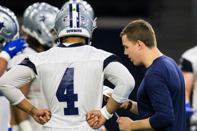 Dallas Cowboys quarterback Dak Prescott (4) talks with offensive coordinator Kellen Moore...