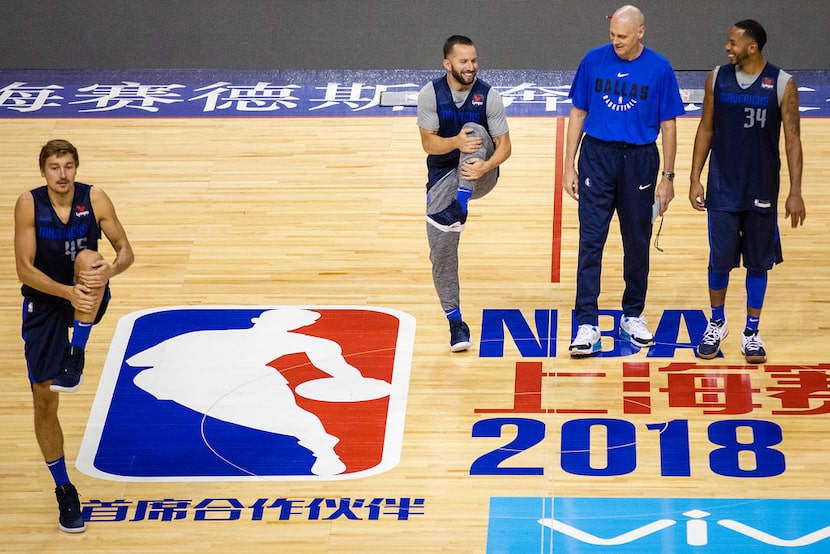 Dallas Mavericks guard J.J. Barea (5) and guard Devin Harris (34) laugh with coach Rick...