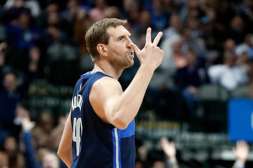 Dallas Mavericks forward Dirk Nowitzki celebrates sinking a 3-point basket during the second...