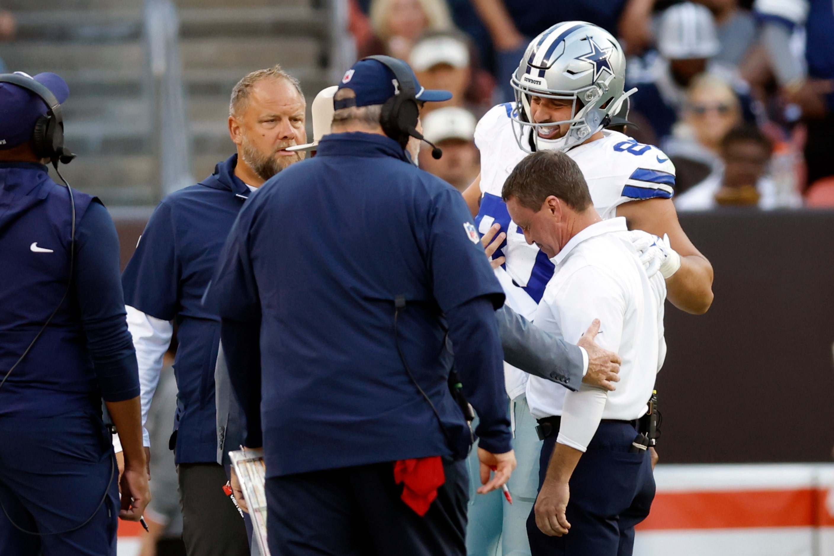 Dallas Cowboys tight end Jake Ferguson (87) is helped off the field after being tackled...