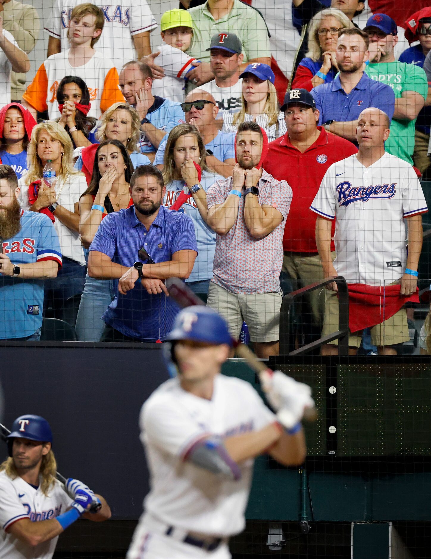 Texas Rangers fans hope for the best from last batter Evan Carter during the bottom of the...