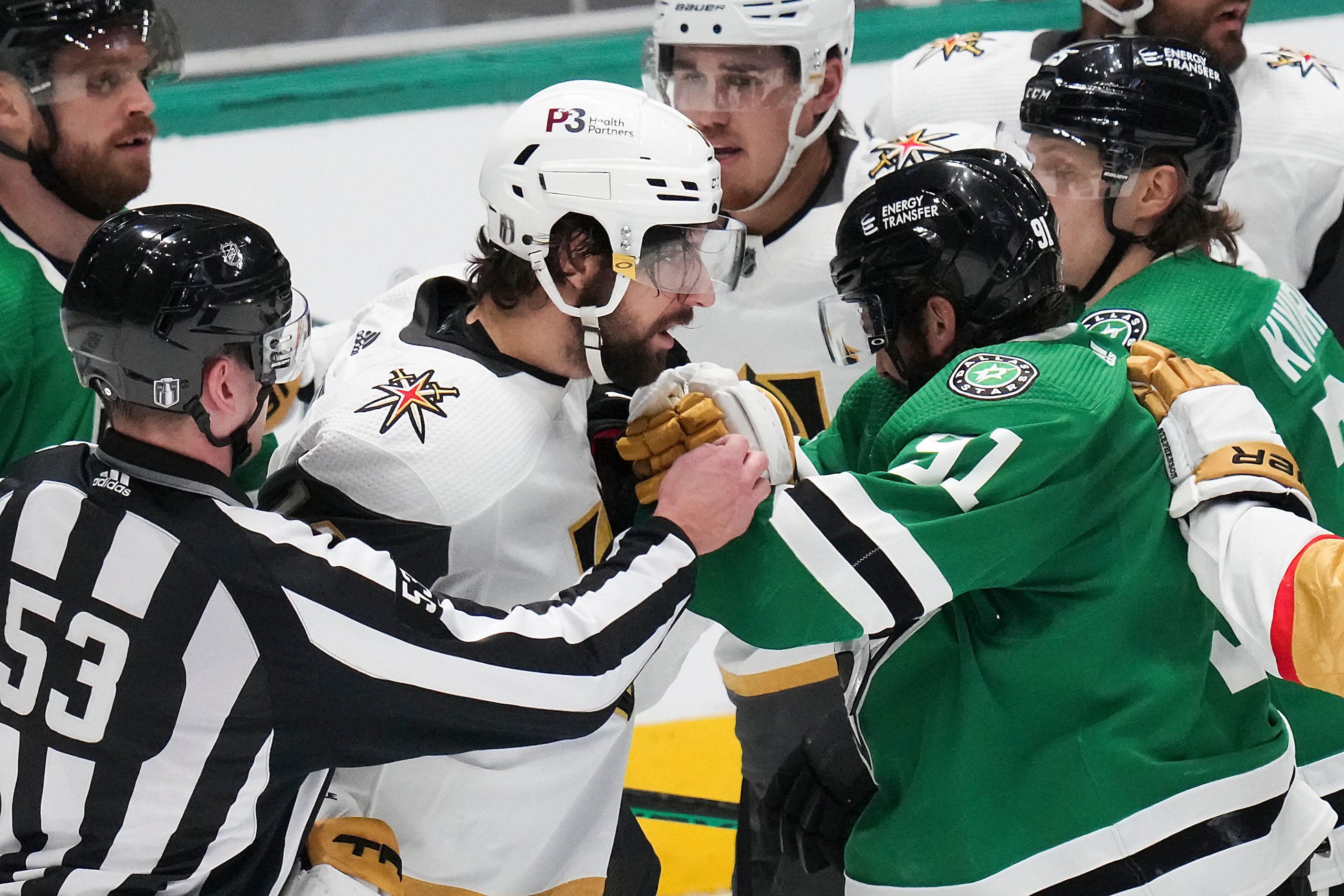 Official try to separate Dallas Stars center Tyler Seguin (91) and Vegas Golden Knights...