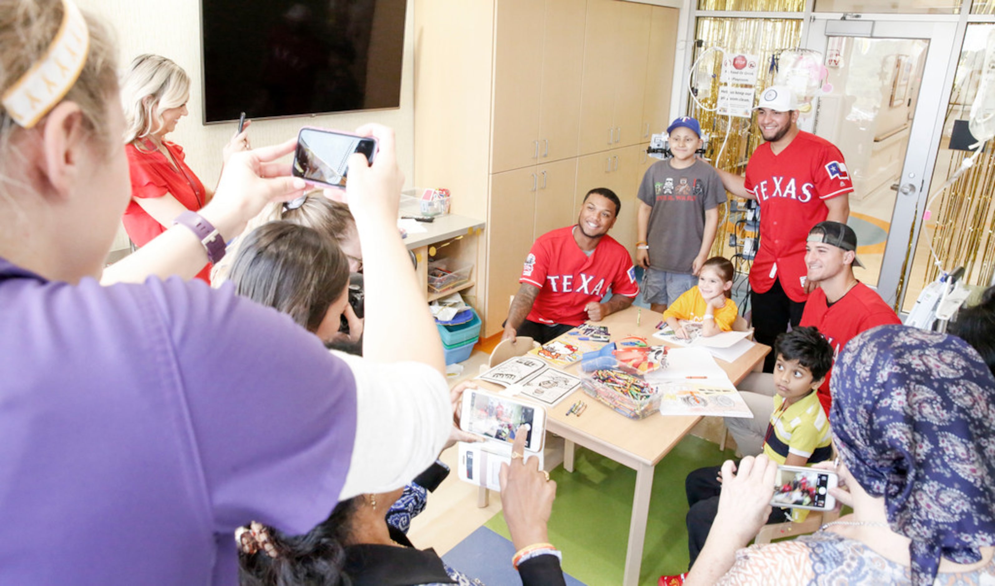 Texas Rangers catcher Jose Trevino, outfielder Willie Calhoun and pitcher Brett Martin take...