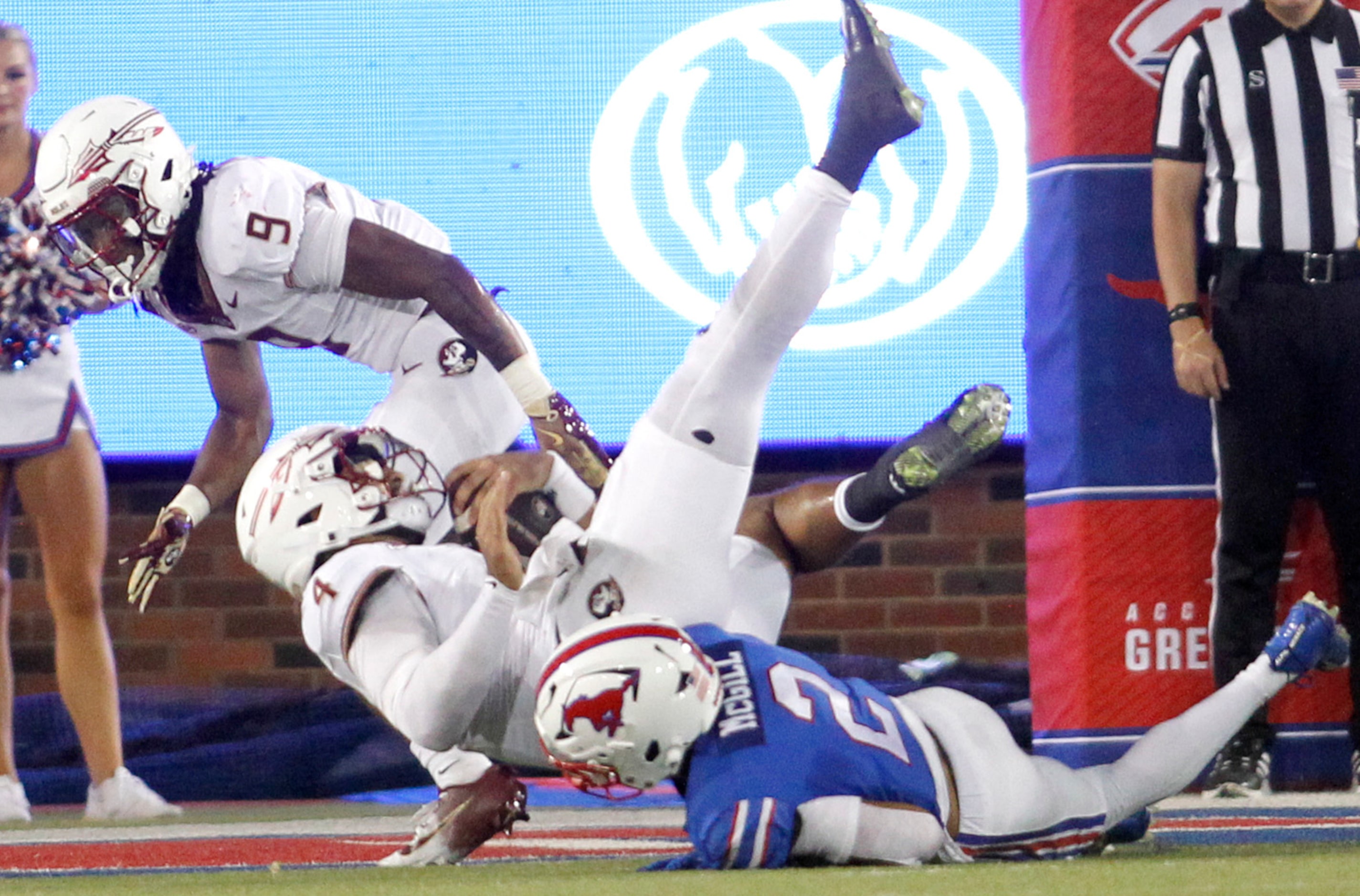 Southern Methodist University safety Jonathan McGill (2), below, upends Florida State...