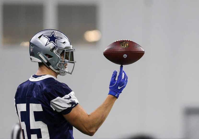 Cowboys linebacker Leighton Vander Esch (55) spins the ball on his finger during a practice...
