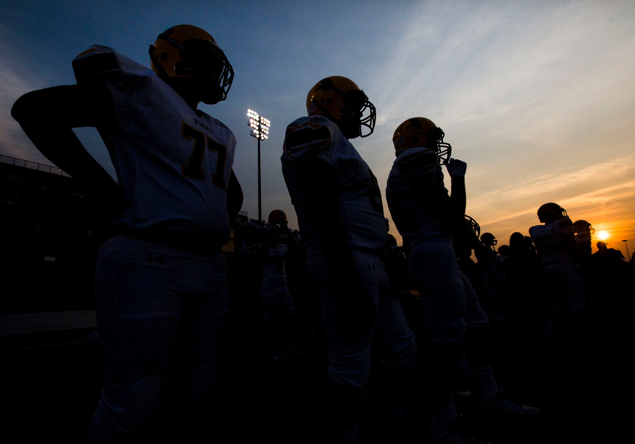 Arlington Lamar High School football players watch their game against Richland High School...