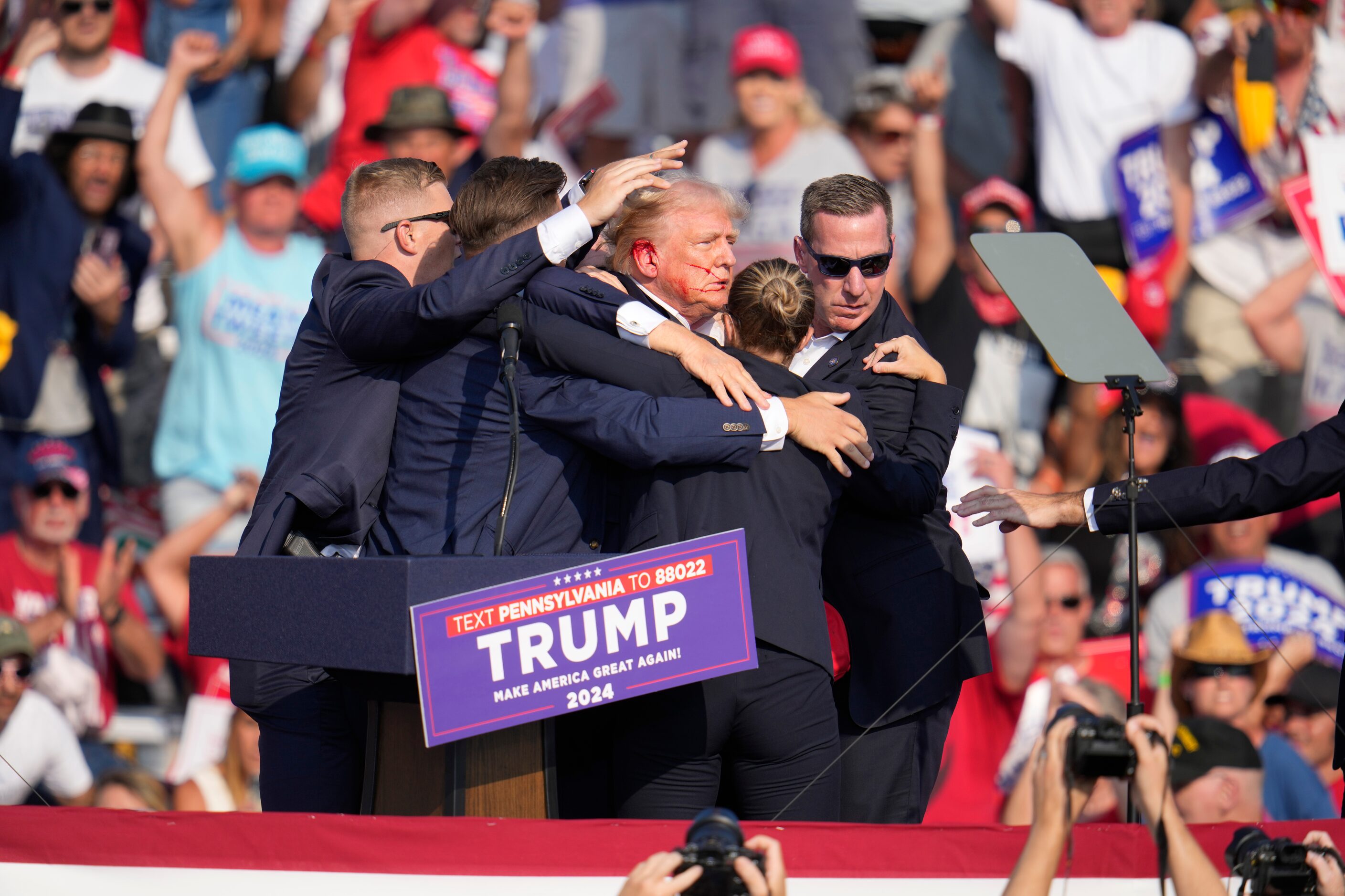 Republican presidential candidate former President Donald Trump is helped off the stage at a...