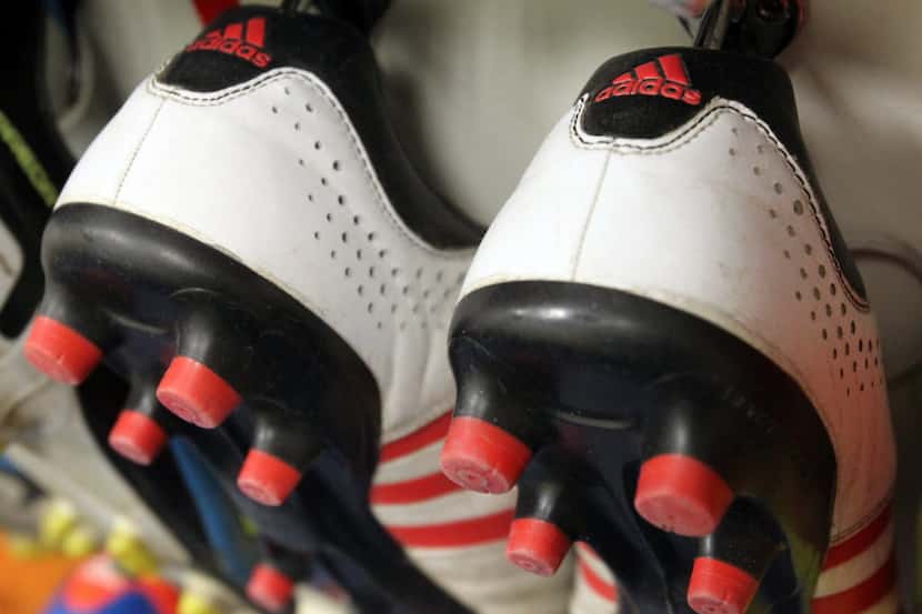 Adidas shoes on the shoe rack where every player hangs their shoes in the locker room for...