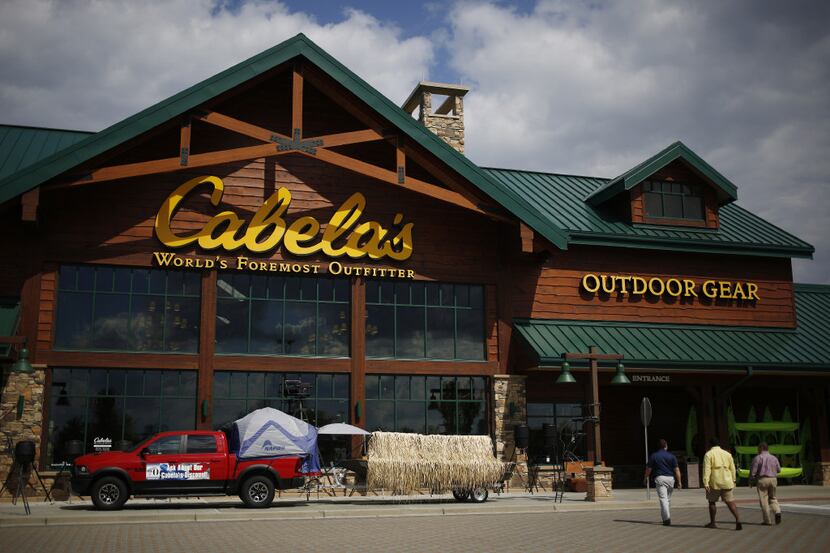 Shoppers walk toward the entrance of a Cabela's Inc. retail store in Greenville, South...