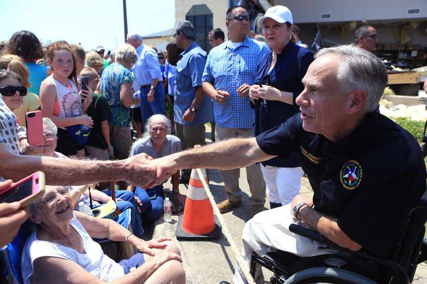 Texas Gov. Greg Abbott shakes hands in Rockport at First Baptist Rockport on Thursday, Aug....