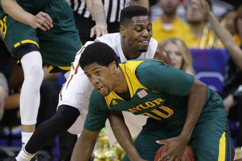 Baylor forward Royce O'Neale (00) gathers the ball while covered by Iowa State forward...