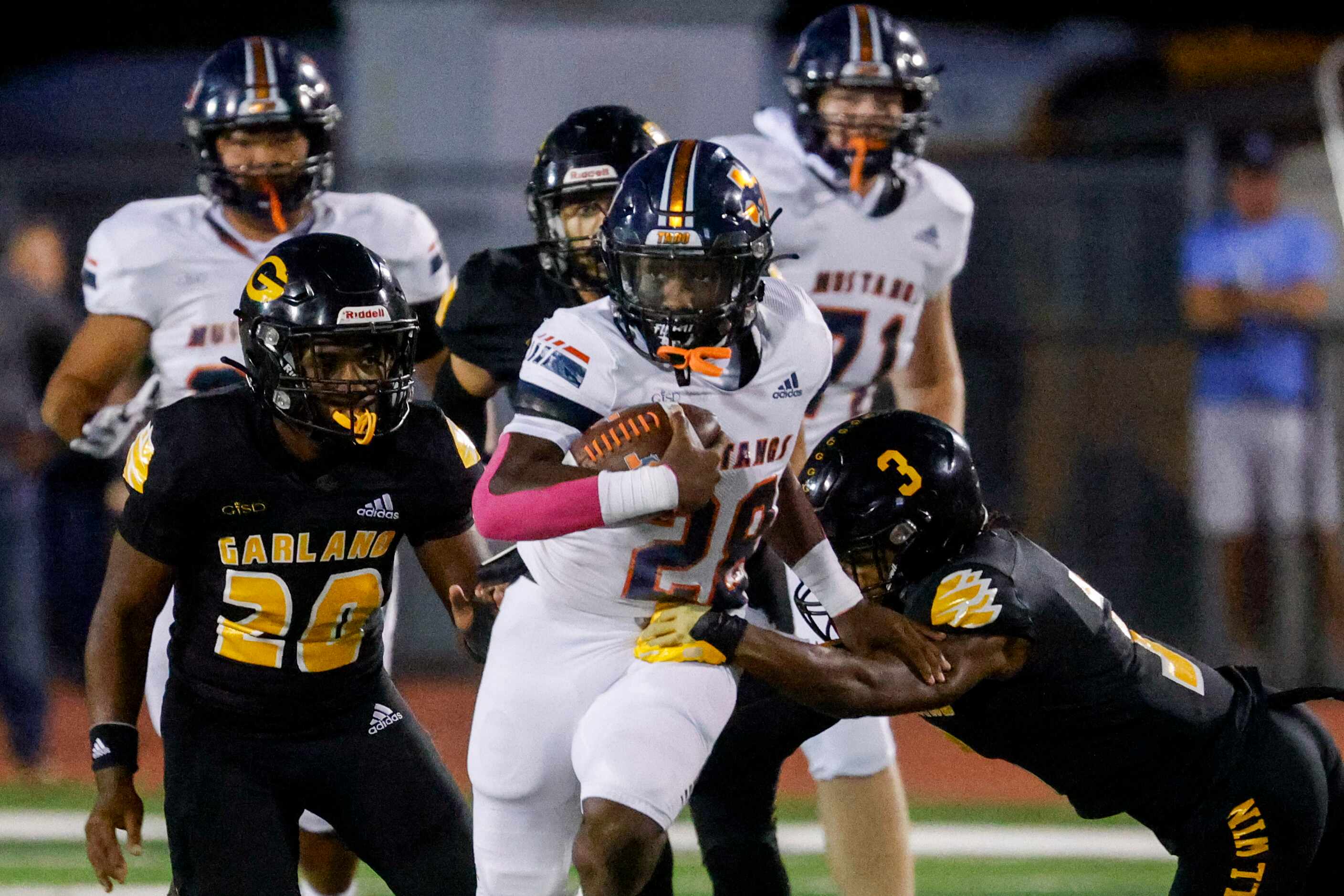 Sachse high school’s Brendon Haygood (28) runs with the ball past Garland high school’s...