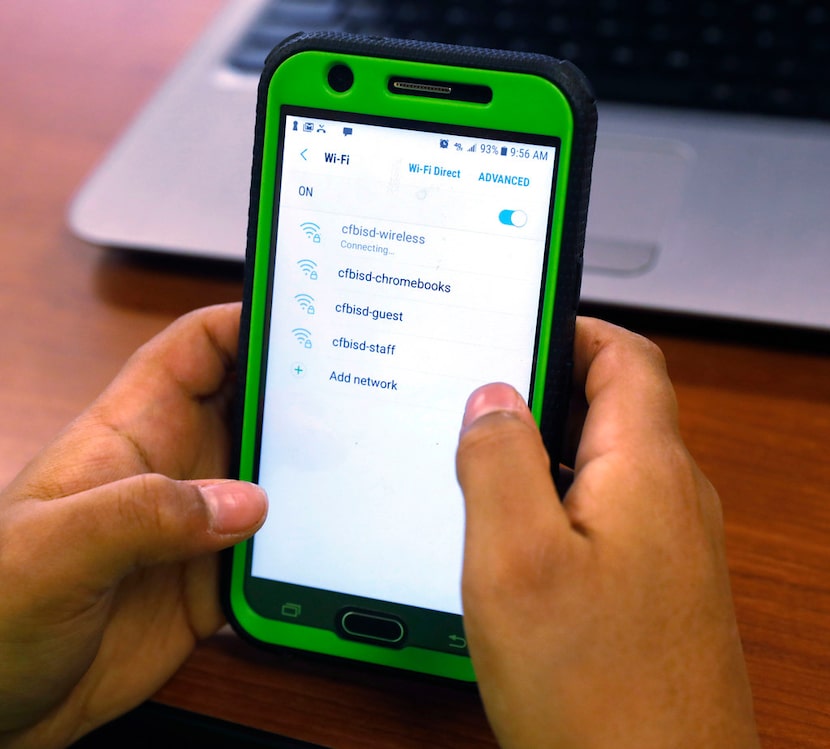 Mikey Shands, 11, works on his phone at Barbara Bush Middle School in Irving. He and other...