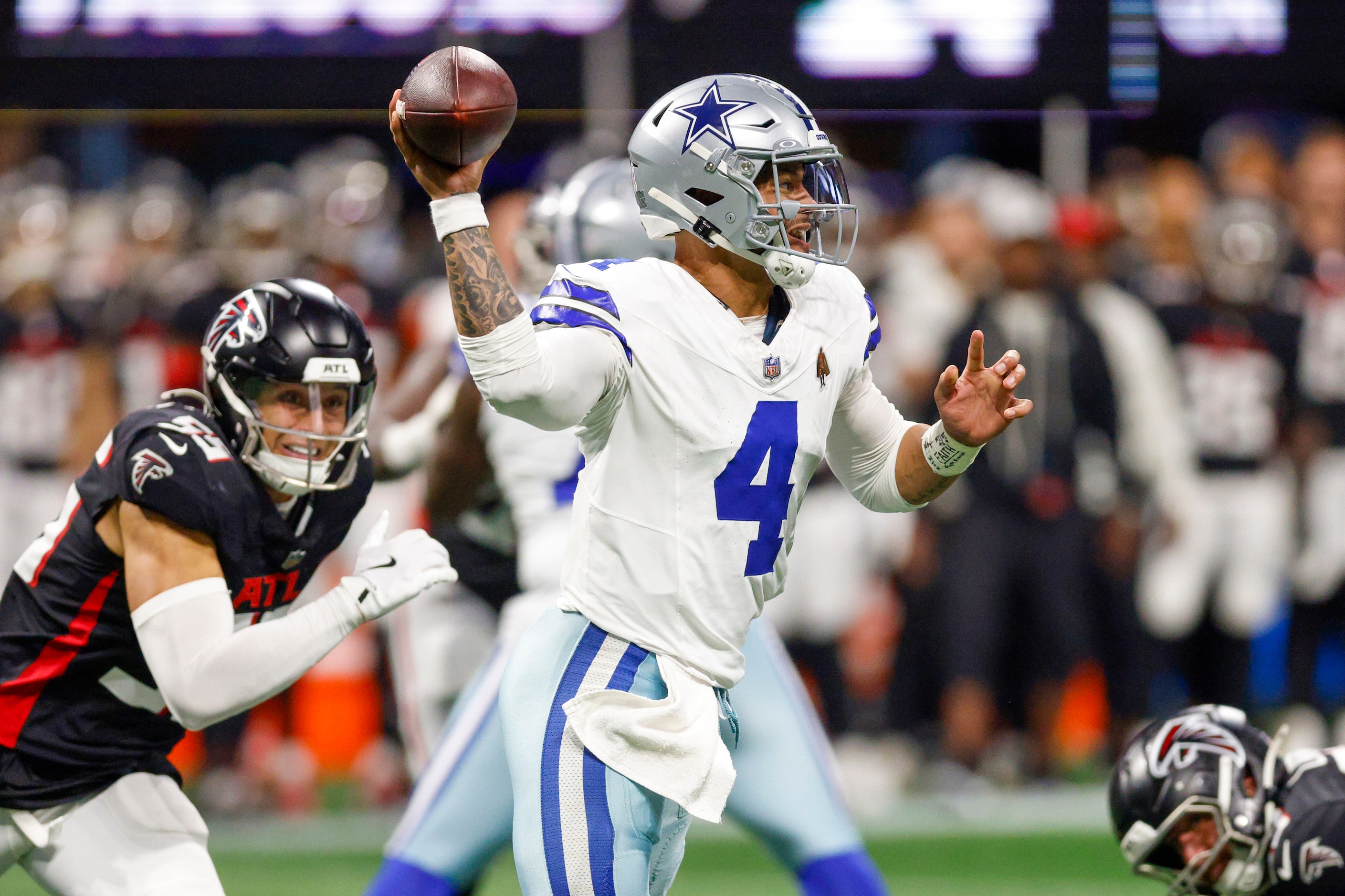 Dallas Cowboys quarterback Dak Prescott (4) throws on the run during the second half against...