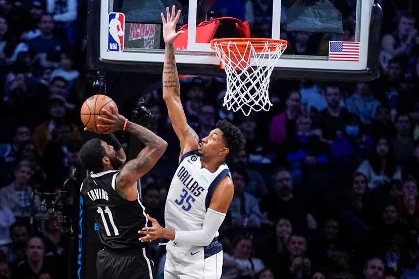 Brooklyn Nets guard Kyrie Irving (11) shoots against Dallas Mavericks center Christian Wood...