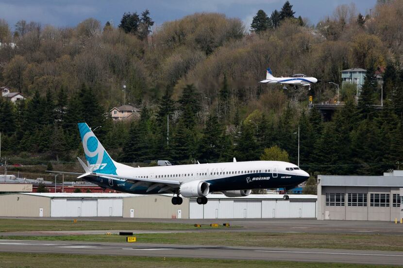 (FILES) This file photo taken on April 13, 2017 shows a chase plane and Boeing 737 MAX 9...