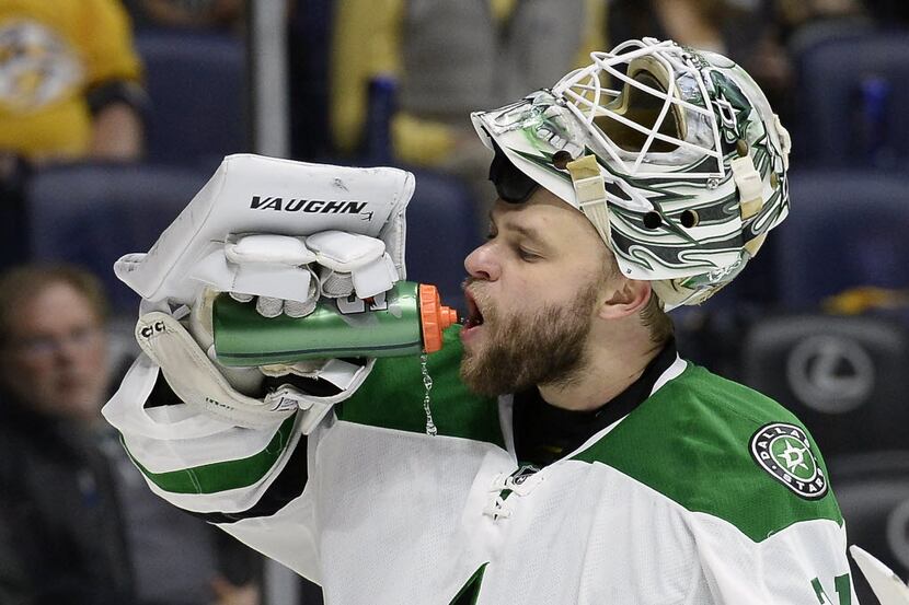Dallas Stars goalie Antti Niemi (31), of Finland, gets a drink during a break in the action...
