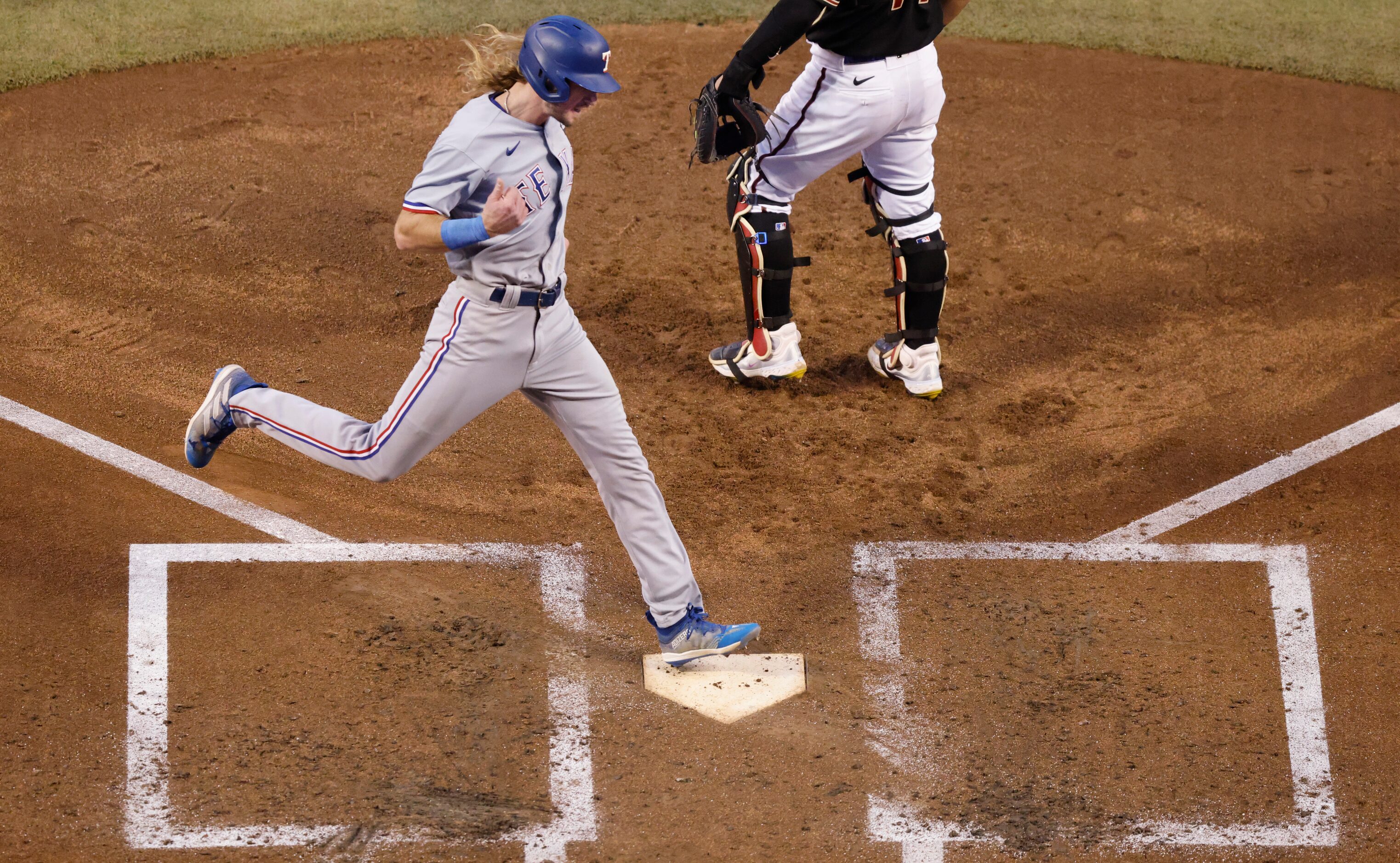 Texas Rangers right fielder Travis Jankowski scores past Arizona Diamondbacks catcher...