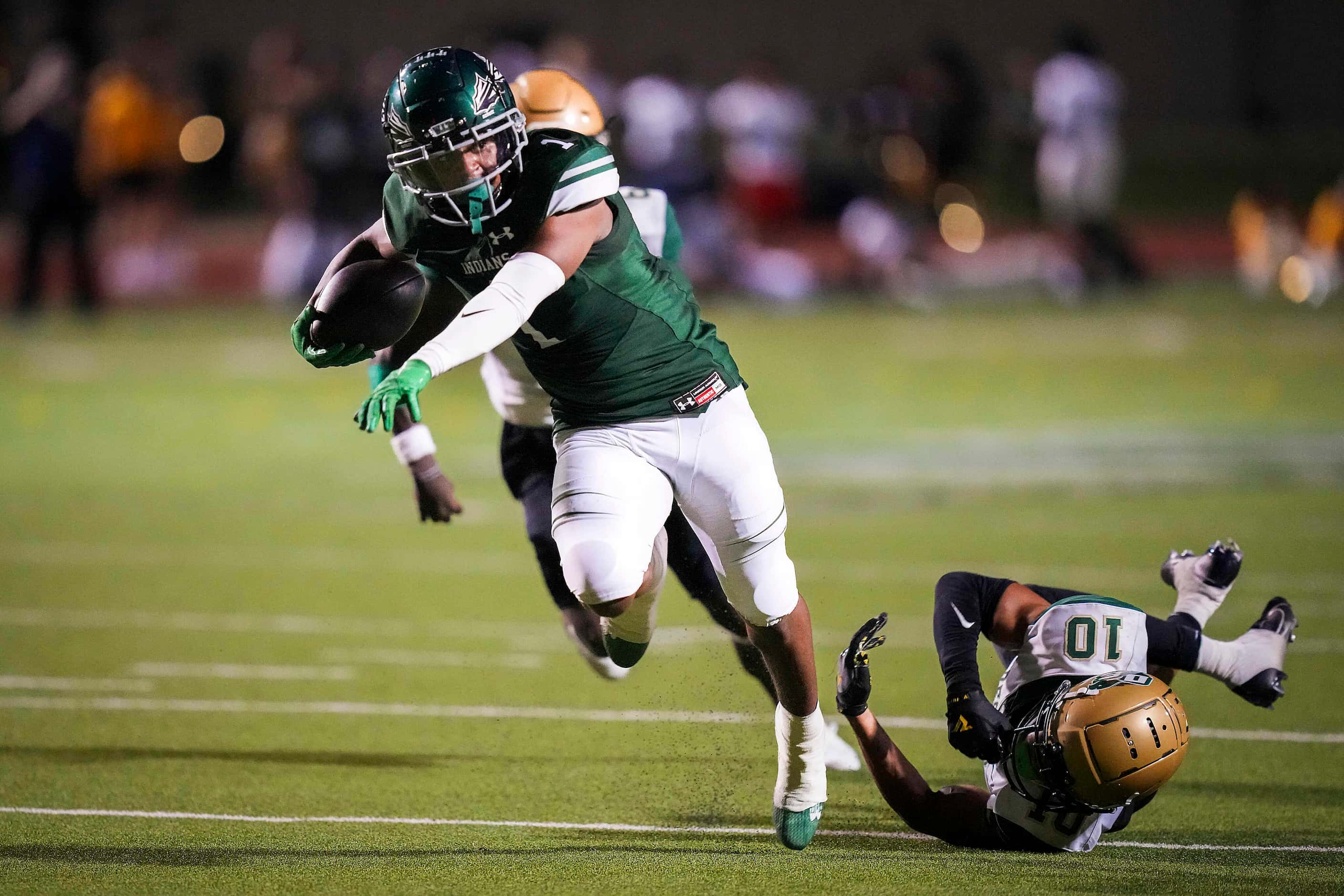 Waxahachie wide receiver Trenton Kidd (1) is tripped up by DeSoto defensive back Makali...