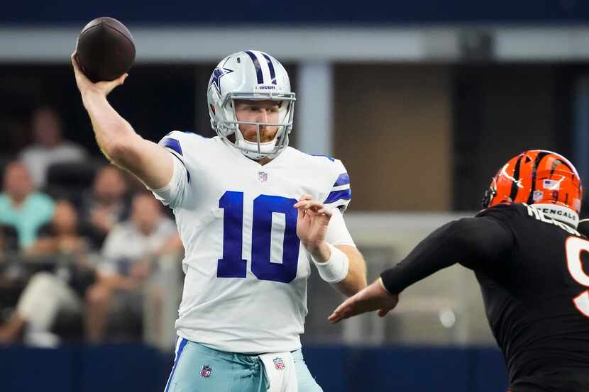 Dallas Cowboys quarterback Cooper Rush (10) throws a pass under pressure from Cincinnati...