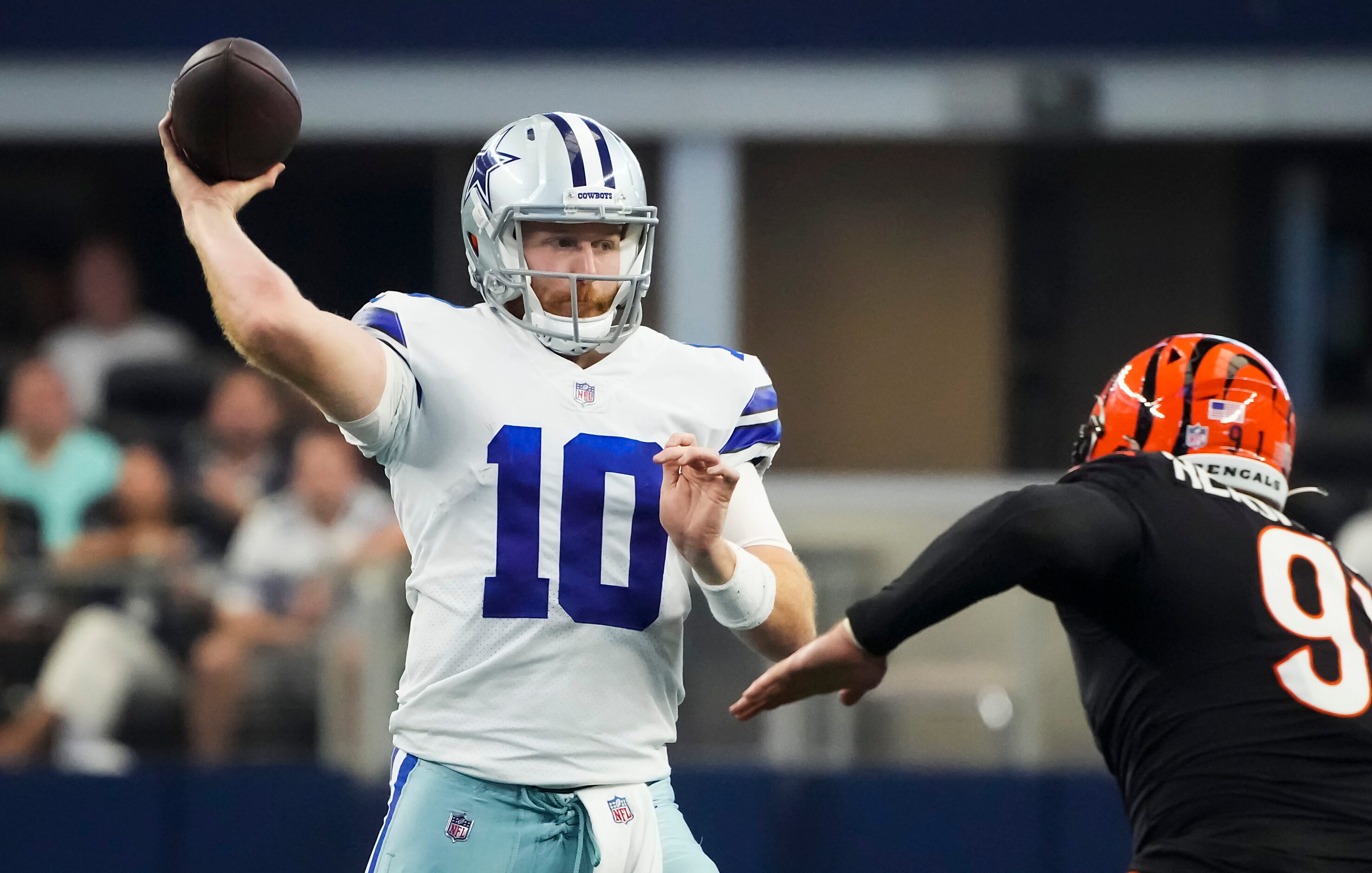 Dallas Cowboys quarterback Cooper Rush (10) throws a pass under pressure from Cincinnati...