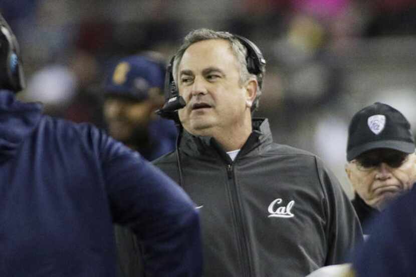 California Coach Sonny Dykes, center, walks along the sideline during the first half of a...