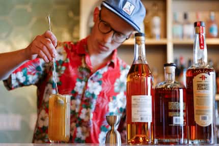 Blake Weaver, head bar manager of Locals Craft Beer & Fine Wine, prepares a cocktail called...