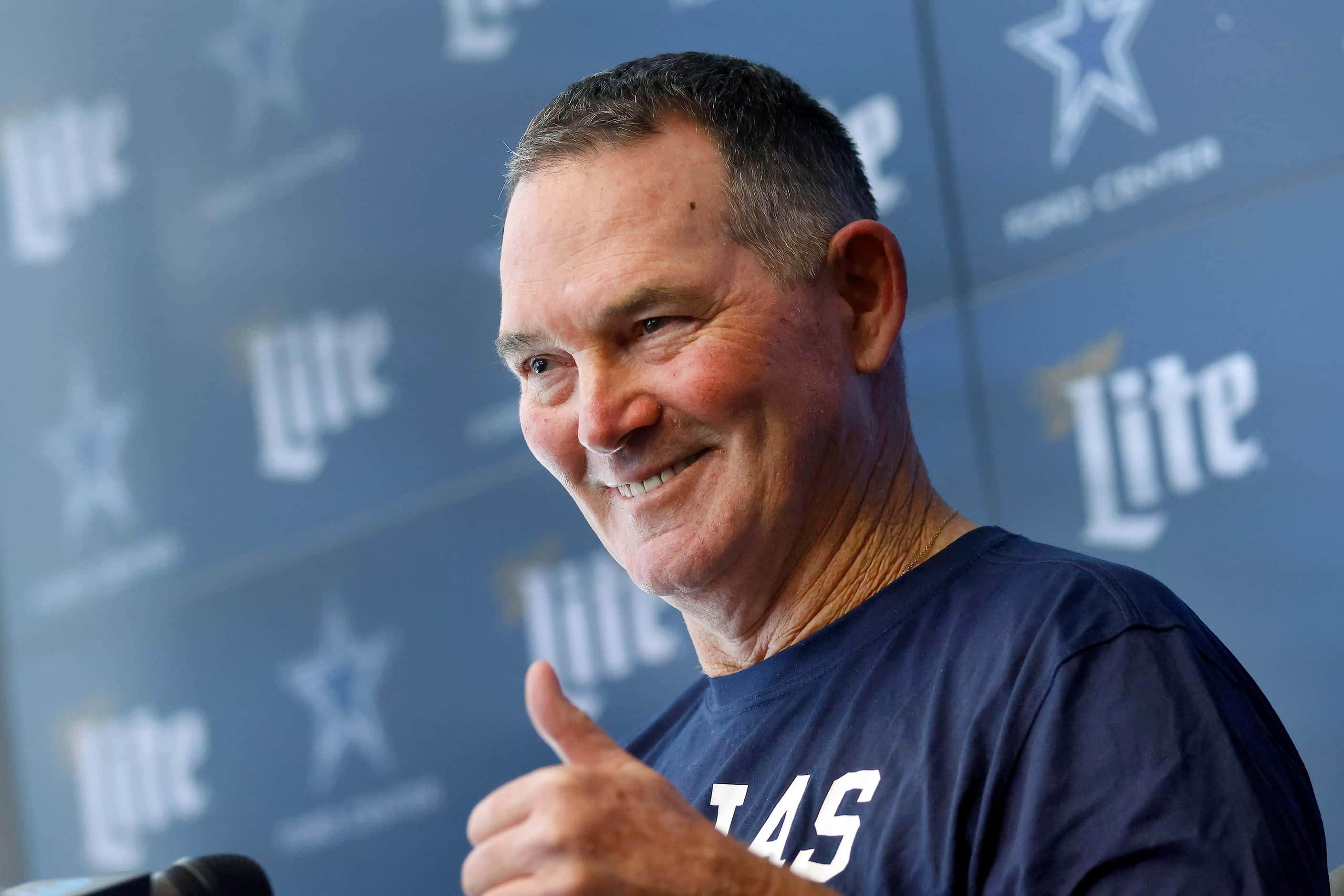 New Dallas Cowboys defensive coordinator Mike Zimmer gives a thumbs up during his...